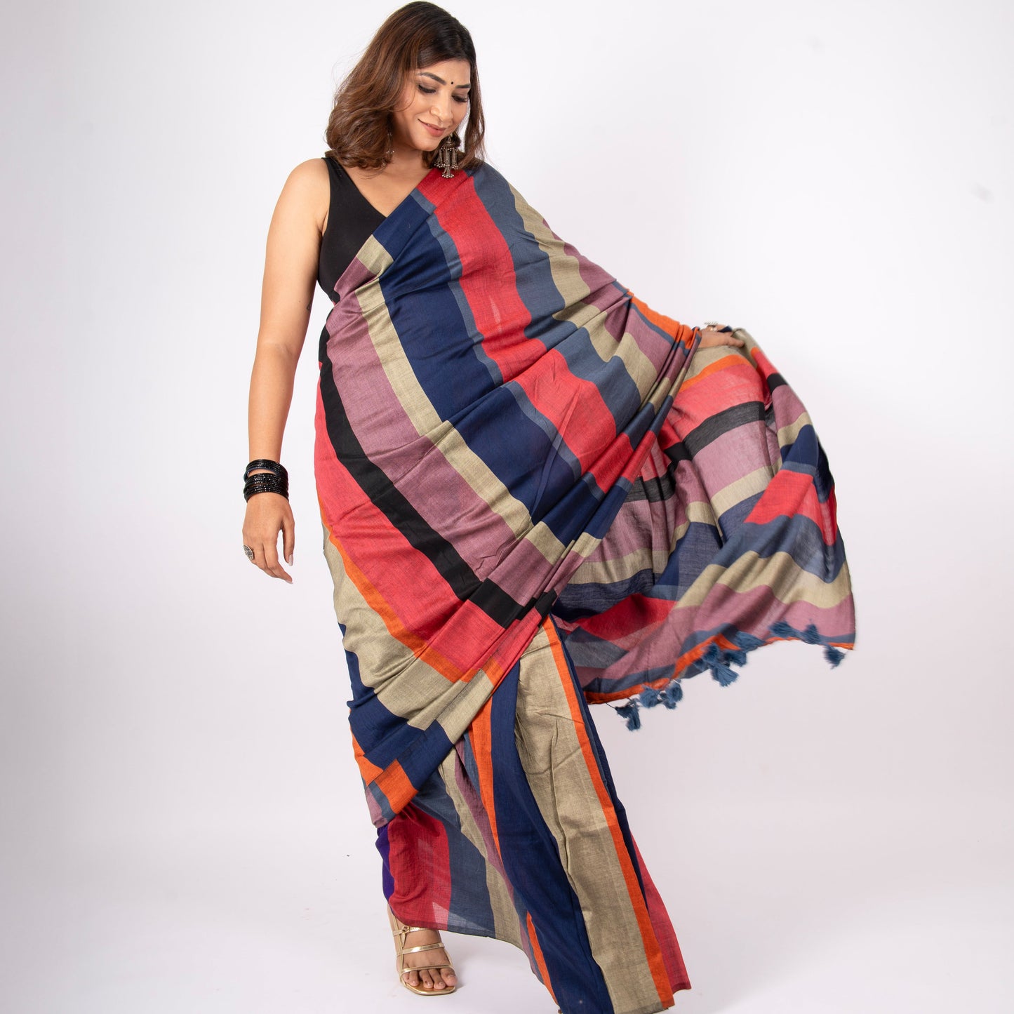 Woman wearing a colorful striped saree on a white background
