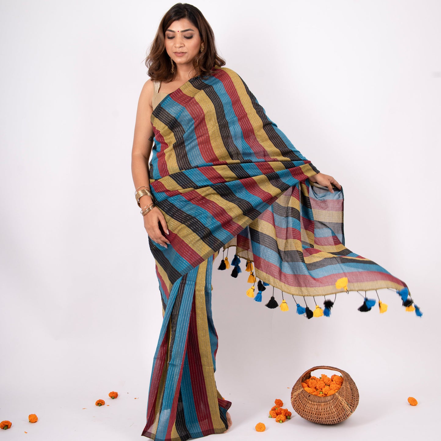 Woman wearing a colorful striped saree with a white background