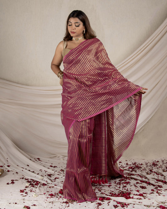 Woman wearing a pink saree with a white background
