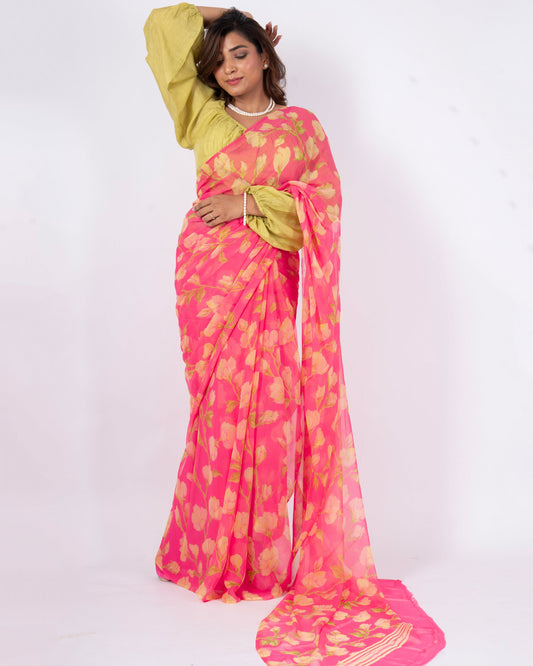 Woman wearing a pink and yellow saree with a white background