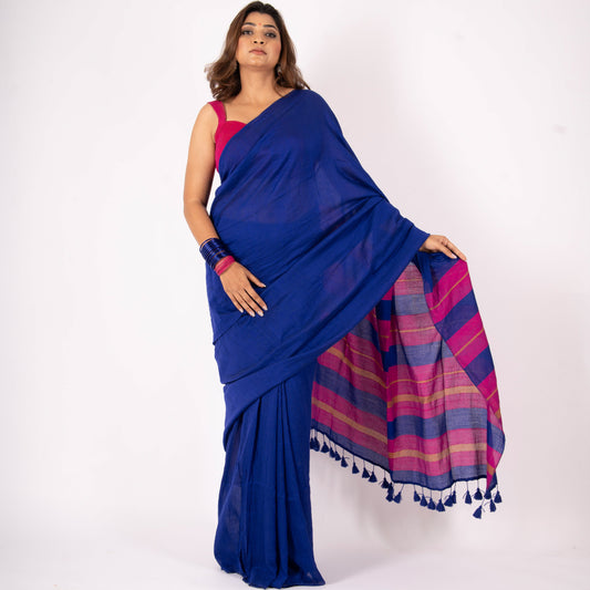Woman wearing a blue saree with a pink and purple plaid pattern on a white background
