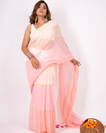 Woman wearing a light pink saree with a white blouse against a white background