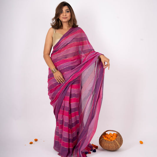 Woman wearing a pink and purple saree with a white background