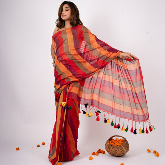 Woman wearing a colorful striped saree with a basket of oranges on a white background