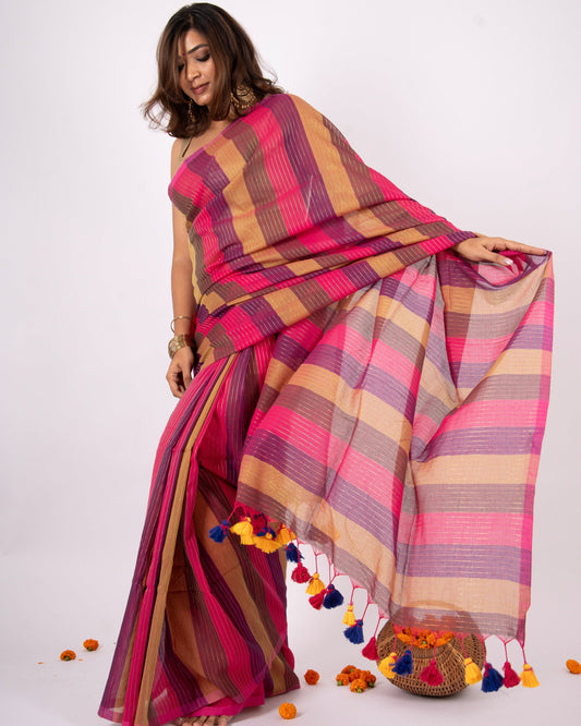 Woman wearing a colorful striped saree with a white background
