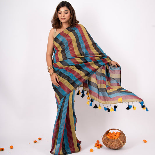 Woman wearing a colorful striped saree with a white background