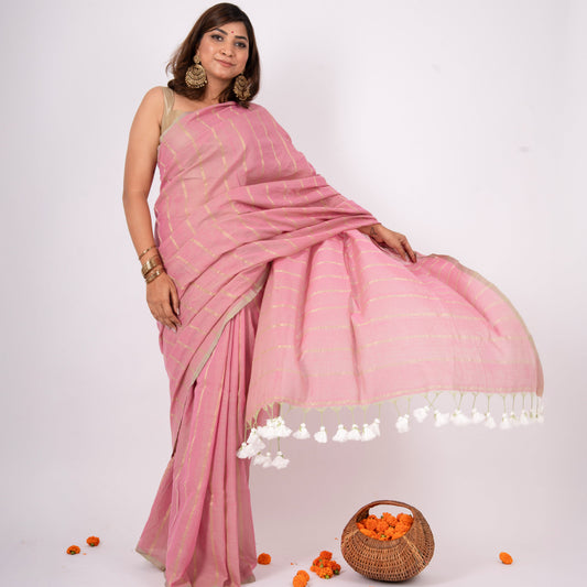 Woman wearing a pink saree with a white background