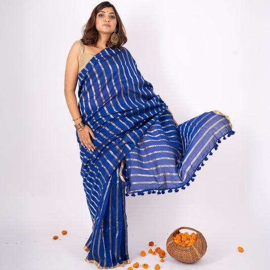 Woman wearing a blue saree with white stripes on a white background