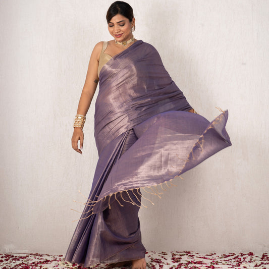 Woman in a purple saree with a white background