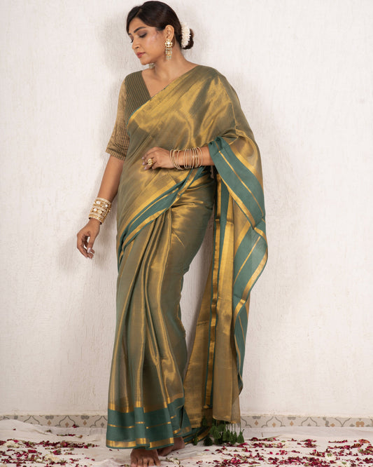 Woman wearing a green saree with a white background