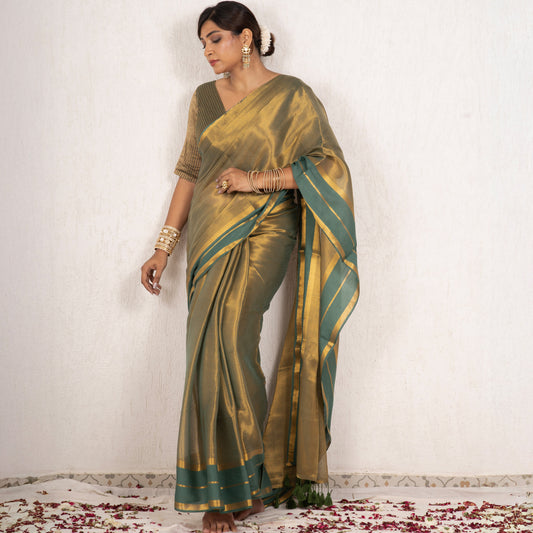 Woman wearing a green saree with a white background