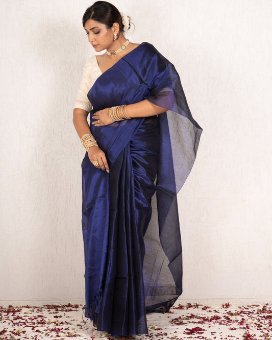 Woman wearing a blue saree with a white background