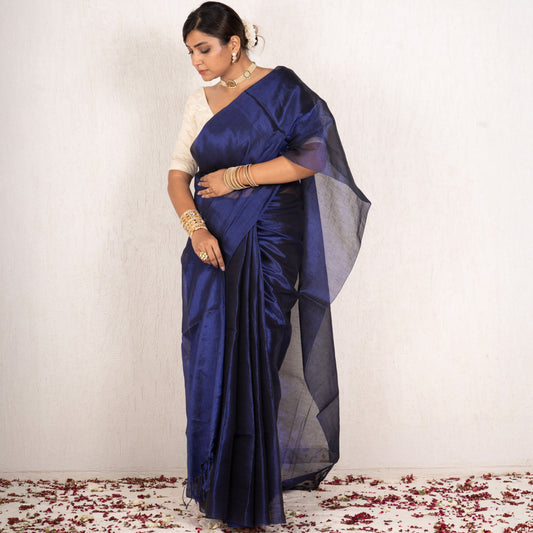 Woman wearing a blue saree with a white background