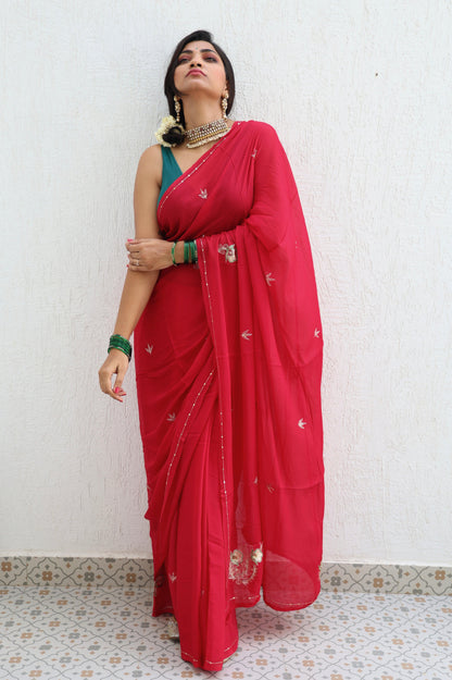 Woman wearing a red saree with a white background